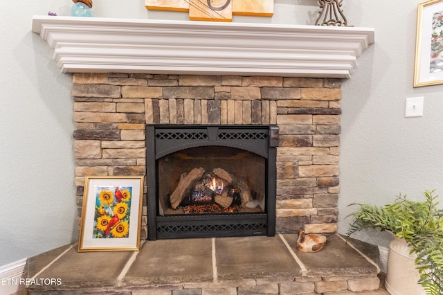 details with a stone fireplace