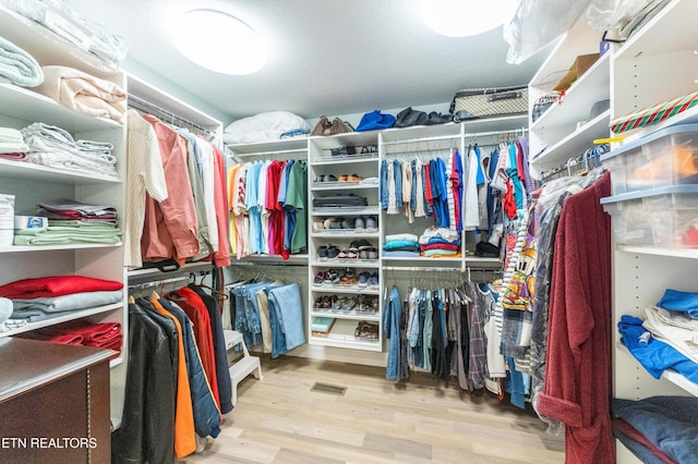 spacious closet featuring light wood-style floors and visible vents