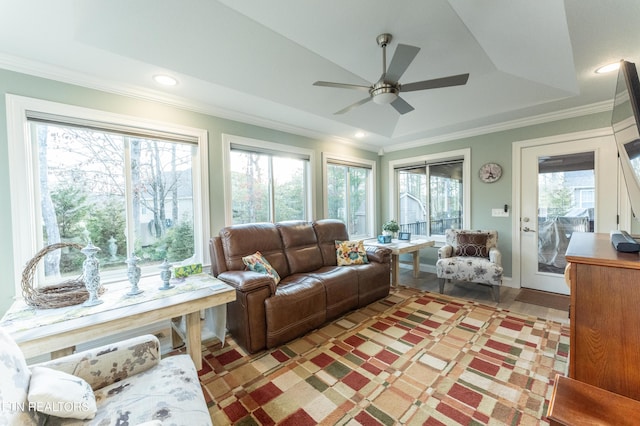 sunroom / solarium featuring a ceiling fan and a tray ceiling