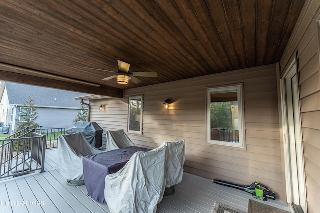 wooden deck featuring a ceiling fan and area for grilling