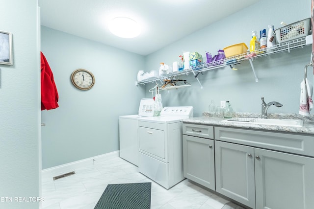 laundry room featuring marble finish floor, washer and clothes dryer, visible vents, a sink, and baseboards