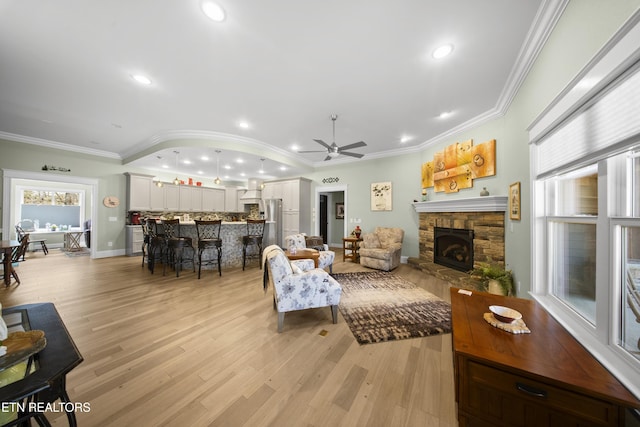 12 Edgemere Ct, Crossville, TN 38558 - living area featuring a fireplace, light wood-style floors, ceiling fan, and ornamental molding