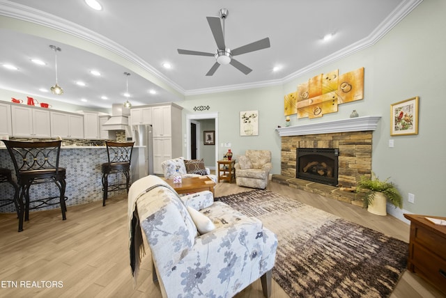 12 Edgemere Ct, Crossville, TN 38558 - living area with crown molding, light wood-style flooring, recessed lighting, a ceiling fan, and a stone fireplace