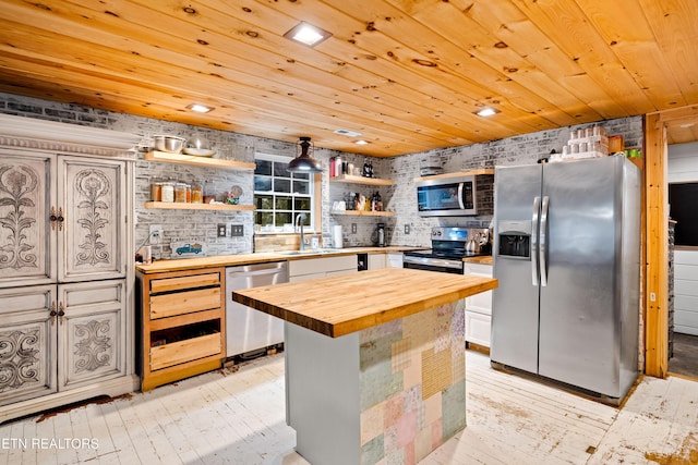 kitchen featuring wood ceiling, a center island, stainless steel appliances, open shelves, and wooden counters