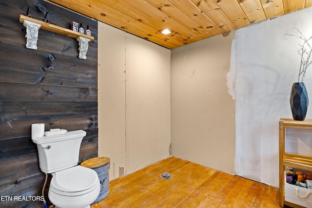 bathroom featuring toilet, wood finished floors, and wood ceiling