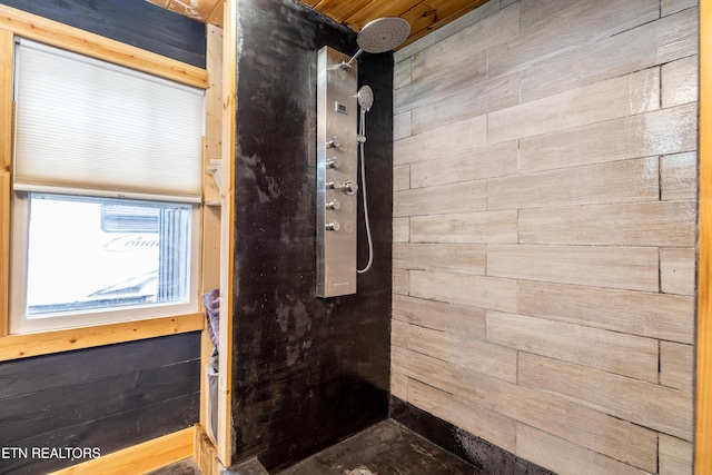 bathroom with a shower and wood walls