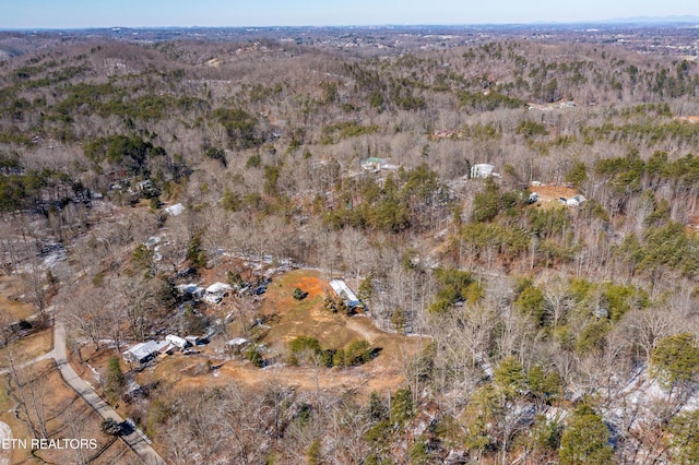 drone / aerial view featuring a forest view