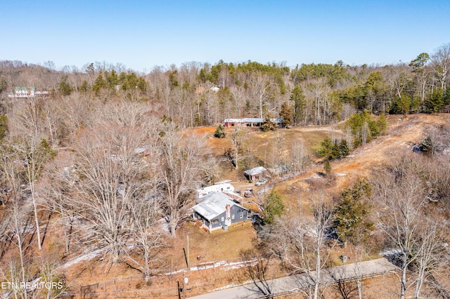 drone / aerial view featuring a forest view