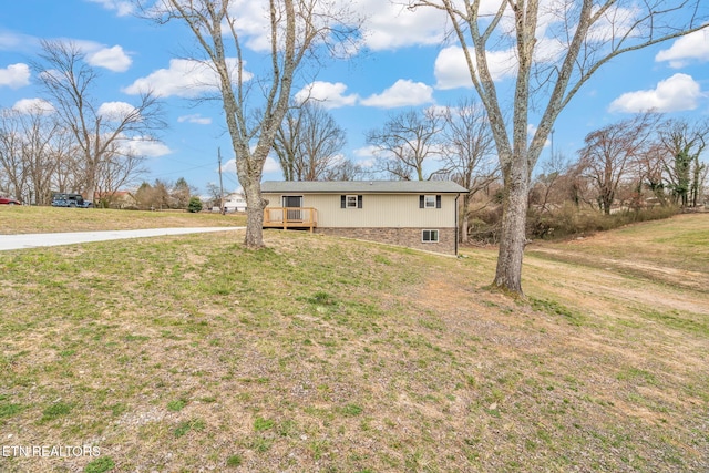 view of front of property with a deck and a front yard