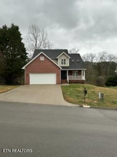 view of front facade with driveway, a porch, and a front yard