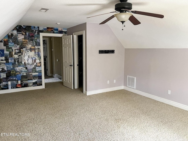 additional living space featuring vaulted ceiling, carpet, visible vents, and baseboards