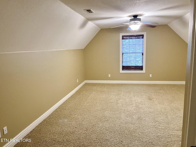 bonus room featuring visible vents, vaulted ceiling, a textured ceiling, and carpet flooring