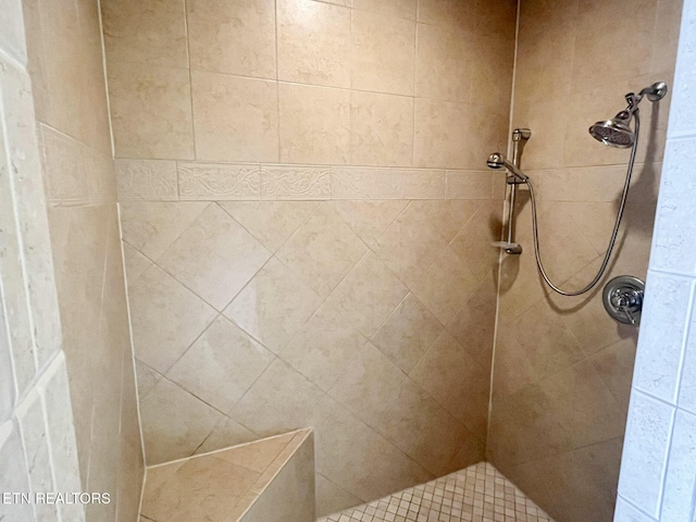 full bath featuring a tile shower