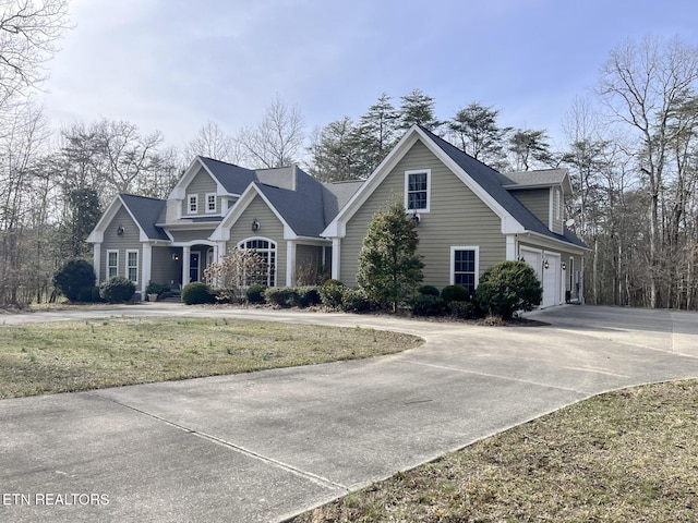 view of front of property featuring concrete driveway and a front yard