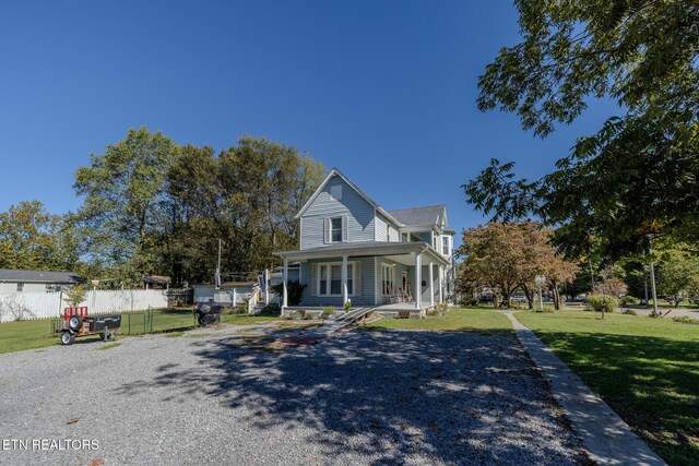 825 E 2nd N St, Morristown, TN 37814 - view of front of home with covered porch, a front lawn, and fence