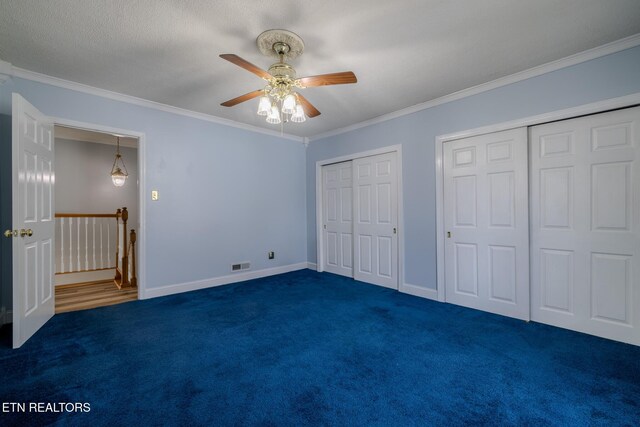 825 E 2nd N St, Morristown, TN 37814 - unfurnished bedroom with ornamental molding, dark carpet, visible vents, and multiple closets