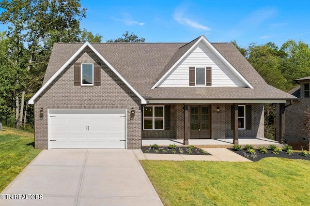 view of front facade featuring a garage, a front yard, concrete driveway, and brick siding