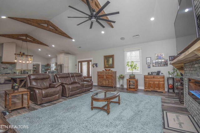living room featuring ceiling fan, a glass covered fireplace, dark wood finished floors, and recessed lighting
