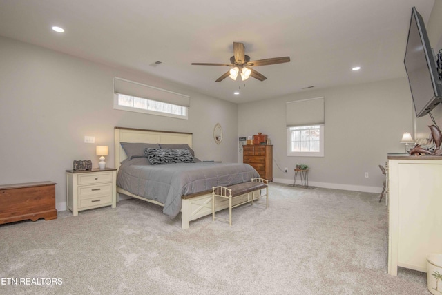 bedroom featuring recessed lighting, light colored carpet, visible vents, and baseboards
