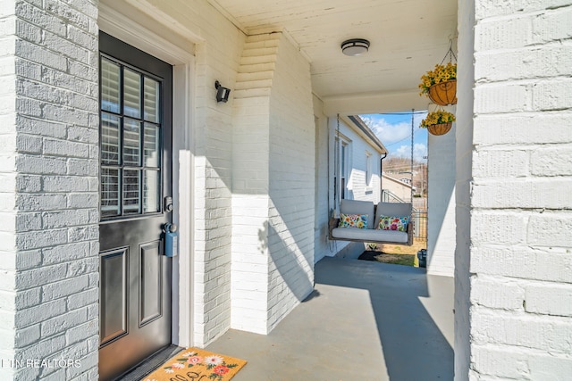 doorway to property featuring brick siding