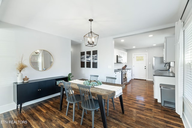 dining area featuring a chandelier, dark wood-style flooring, baseboards, and recessed lighting