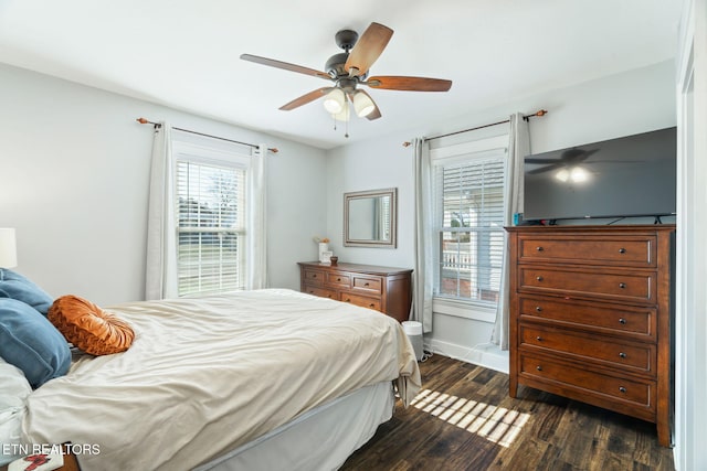 bedroom featuring dark wood-type flooring, a ceiling fan, and baseboards