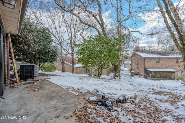 yard covered in snow featuring cooling unit