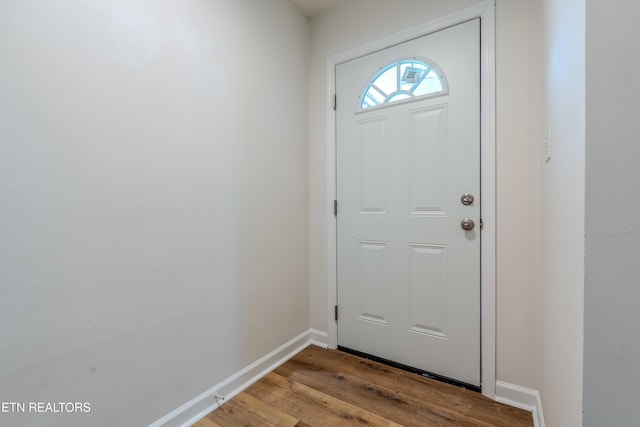 doorway with light wood-style flooring and baseboards