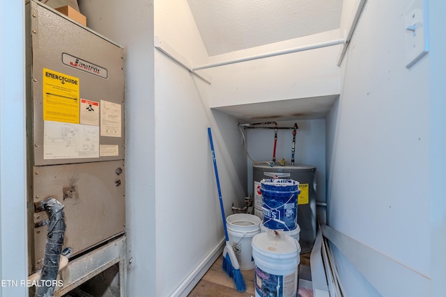 utility room featuring water heater and heating unit