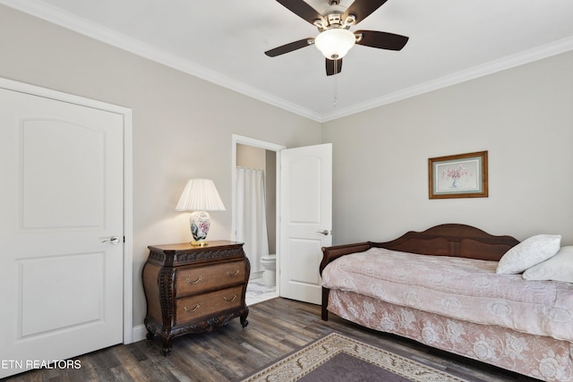 bedroom featuring ornamental molding, dark wood finished floors, and a ceiling fan