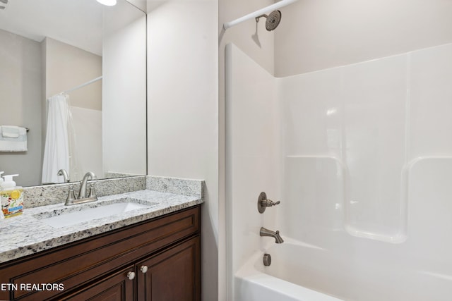 bathroom with shower / bath combination with curtain and vanity