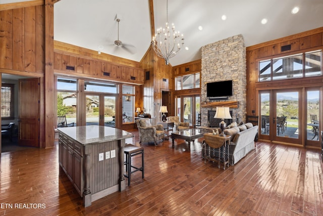 kitchen featuring open floor plan, french doors, plenty of natural light, and wooden walls