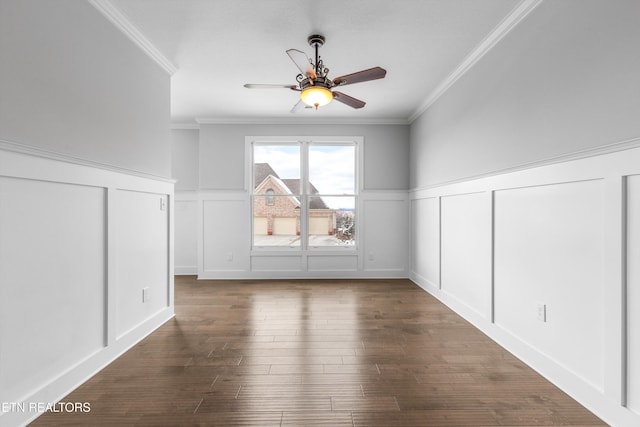 additional living space featuring dark wood-style flooring, a wainscoted wall, ceiling fan, and a decorative wall