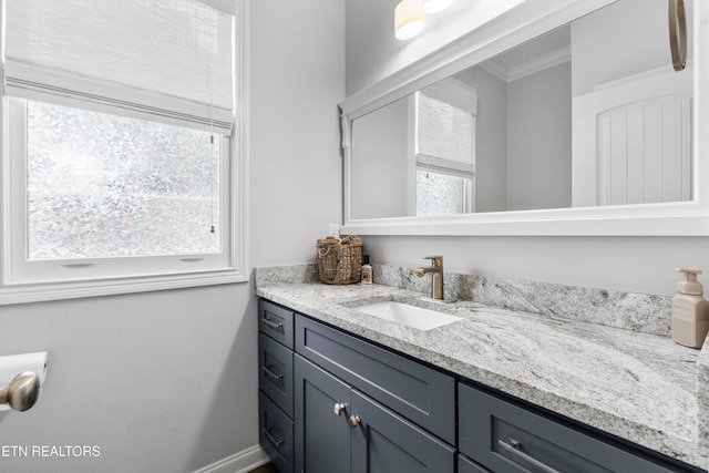 bathroom featuring ornamental molding and vanity