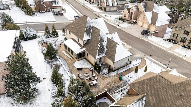 snowy aerial view featuring a residential view