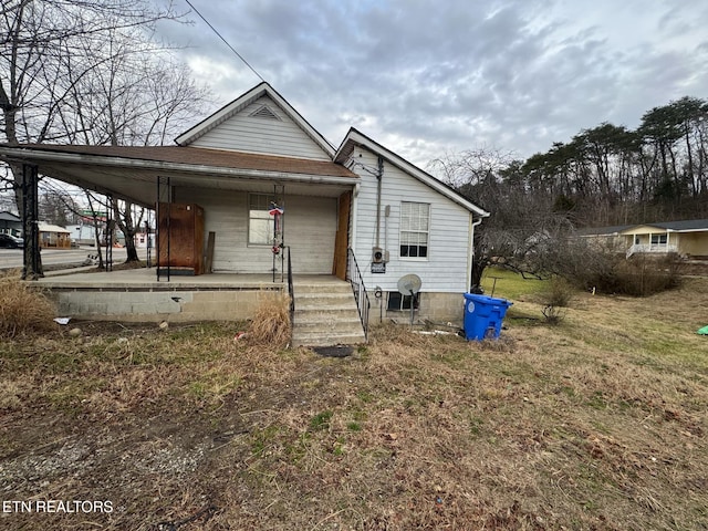 view of front of house with a porch and a carport