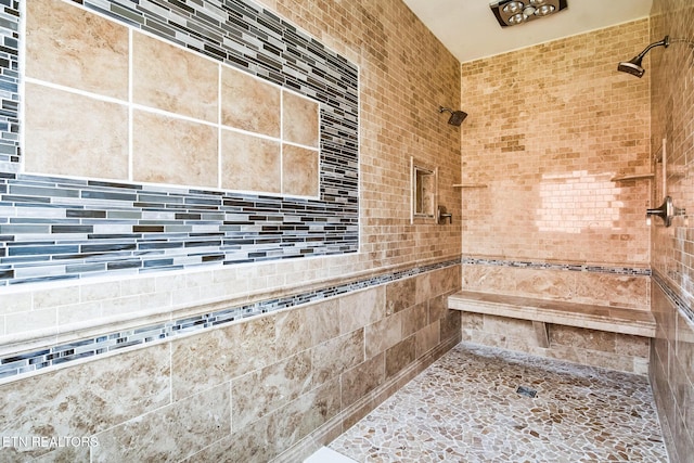 bathroom with tiled shower