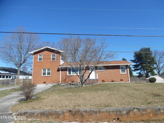 view of front facade with crawl space, fence, a front lawn, and brick siding