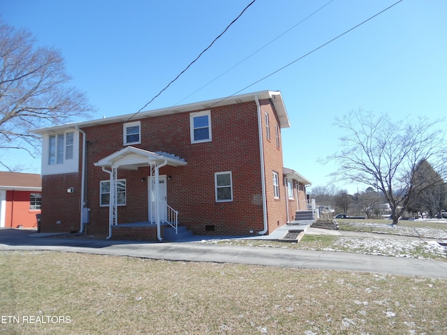 view of front facade with brick siding and crawl space