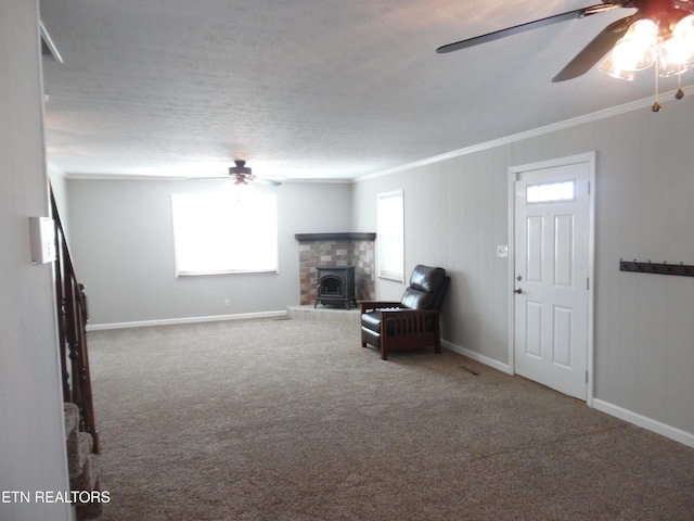 unfurnished living room with carpet floors, crown molding, and ceiling fan