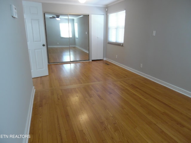 unfurnished bedroom with light wood finished floors and baseboards