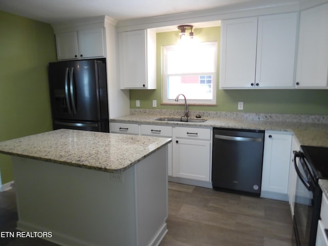 kitchen with black appliances, a sink, and white cabinets