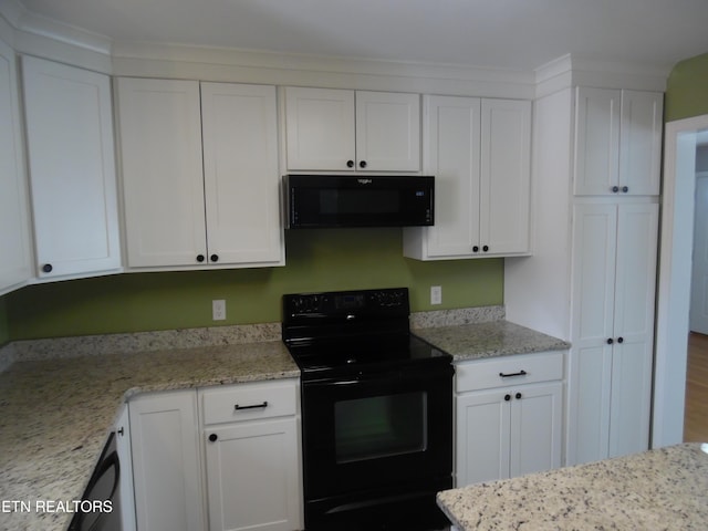 kitchen with light stone counters, white cabinetry, and black appliances