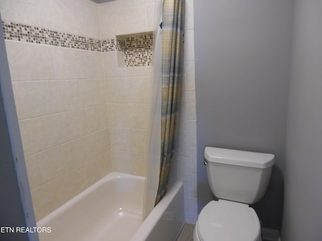 bathroom featuring toilet and shower / tub combo