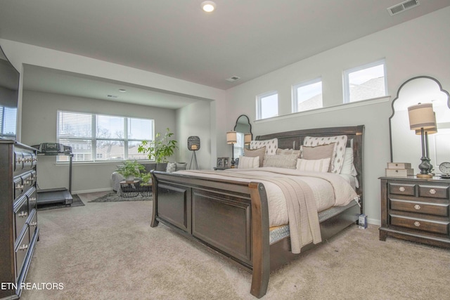 bedroom featuring baseboards, visible vents, and light colored carpet