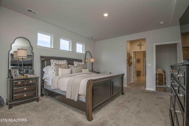 bedroom featuring visible vents, light carpet, and baseboards