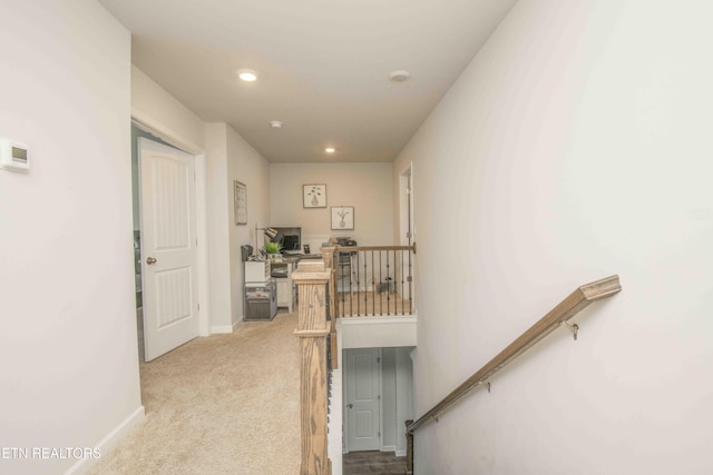 corridor with recessed lighting, baseboards, light carpet, and an upstairs landing