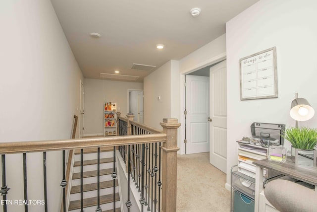 corridor featuring recessed lighting, attic access, light colored carpet, and an upstairs landing