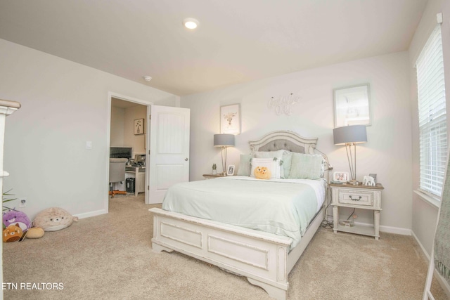 bedroom with baseboards and light colored carpet