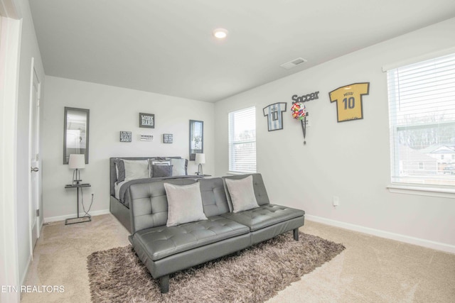 bedroom featuring baseboards, visible vents, and light colored carpet